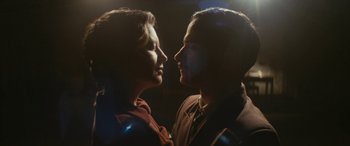 Movie still from “Neruda” (2016), directed by Pablo Larraín – A man and a woman face to face in the dark; Close Up shot, Low angle