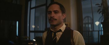 Movie still from “Neruda” (2016), directed by Pablo Larraín – A man with a mustache wearing a vest and a tie; Close Up shot, Low angle