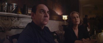 Movie still from “Neruda” (2016), directed by Pablo Larraín – A person sitting in a chair; Medium shot, Over the shoulder angle