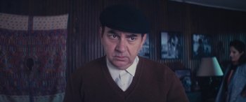 Movie still from “Neruda” (2016), directed by Pablo Larraín – A person wearing a hat; Close Up shot, Low angle