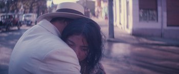 Movie still from “Neruda” (2016), directed by Pablo Larraín – A man and a woman hugging on a street; Extreme Close Up shot, High angle