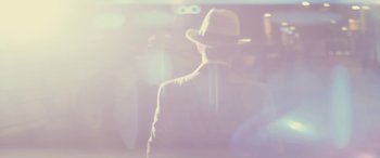 Movie still from “Neruda” (2016), directed by Pablo Larraín – A man wearing a hat standing in a room; Close Up shot, Low angle