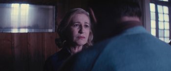 Movie still from “Neruda” (2016), directed by Pablo Larraín – An older woman is looking at the camera; Close Up shot, Over the shoulder angle