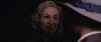 Movie still from “Neruda” (2016), directed by Pablo Larraín – A person with blonde curly hair; Close Up shot, Over the shoulder angle