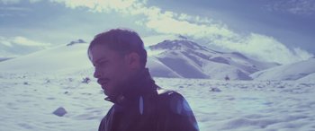 Movie still from “Neruda” (2016), directed by Pablo Larraín – A man standing in the middle of a snow covered field; Medium shot, High angle