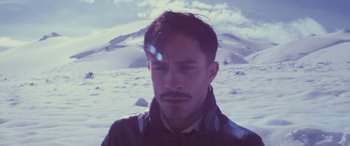 Movie still from “Neruda” (2016), directed by Pablo Larraín – A person wearing a jacket in the snow; Close Up shot, High angle