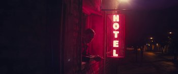 Movie still from “Neruda” (2016), directed by Pablo Larraín – A man looking out of the window of a hotel room; Wide shot, Low angle
