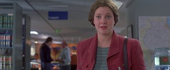 Movie still from “Never Been Kissed” (1999), directed by Raja Gosnell – A woman in a red jacket standing in a room; Close Up shot, Low angle