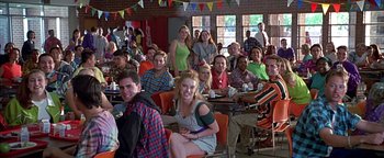 Movie still from “Never Been Kissed” (1999), directed by Raja Gosnell – A group of people sitting at tables in a room; Wide shot, High angle