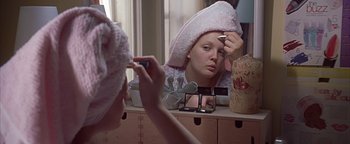 Movie still from “Never Been Kissed” (1999), directed by Raja Gosnell – A woman is taking a picture of herself in the mirror; Close Up shot, Over the shoulder angle