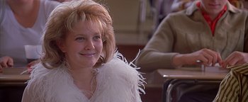 Movie still from “Never Been Kissed” (1999), directed by Raja Gosnell – A young woman with a white dress and a feather boa; Close Up shot, Low angle
