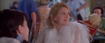 Movie still from “Never Been Kissed” (1999), directed by Raja Gosnell – A person wearing a feather boa; Close Up shot, Over the shoulder angle
