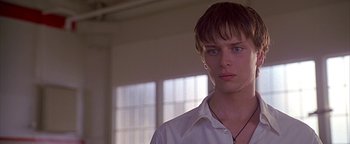 Movie still from “Never Been Kissed” (1999), directed by Raja Gosnell – A man in a white shirt is looking at the camera; Close Up shot, Low angle