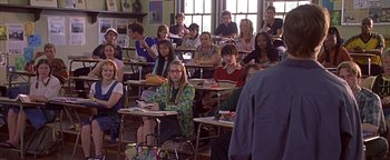 Movie still from “Never Been Kissed” (1999), directed by Raja Gosnell – A group of people sitting at desks in a classroom; Wide shot, High angle