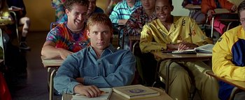 Movie still from “Never Been Kissed” (1999), directed by Raja Gosnell – A group of young men sitting in a classroom; Medium shot, Low angle