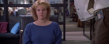 Movie still from “Never Been Kissed” (1999), directed by Raja Gosnell – A woman sitting in an office chair in front of a desk; Medium shot, Over the shoulder angle