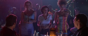 Movie still from “Never Been Kissed” (1999), directed by Raja Gosnell – A group of people standing around a table; Medium shot, Low angle