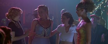 Movie still from “Never Been Kissed” (1999), directed by Raja Gosnell – Two young women are holding hands and smiling; Medium shot, Low angle