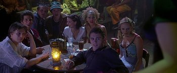 Movie still from “Never Been Kissed” (1999), directed by Raja Gosnell – A group of people sitting at a table with drinks; Medium shot, High angle