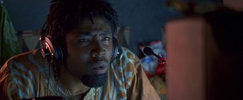 Movie still from “Never Been Kissed” (1999), directed by Raja Gosnell – A man with a beard is listening to music; Close Up shot, Low angle