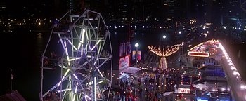 Movie still from “Never Been Kissed” (1999), directed by Raja Gosnell – An overhead view of an amusement park at night; Extreme Wide shot, High angle