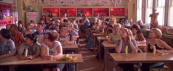 Movie still from “Never Been Kissed” (1999), directed by Raja Gosnell – A group of people sitting at tables eating food; Wide shot, High angle