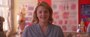 Movie still from “Never Been Kissed” (1999), directed by Raja Gosnell – A woman with blonde hair is smiling for the camera; Close Up shot, Low angle