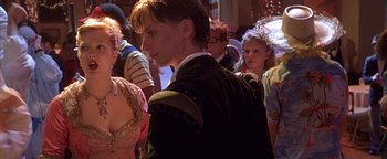 Movie still from “Never Been Kissed” (1999), directed by Raja Gosnell – A group of people standing in a room; Medium shot, Over the shoulder angle