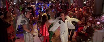 Movie still from “Never Been Kissed” (1999), directed by Raja Gosnell – A group of people dressed up as elvis presley dancing; Wide shot, High angle