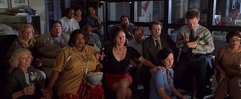 Movie still from “Never Been Kissed” (1999), directed by Raja Gosnell – A group of people sitting in a room together; Wide shot, High angle