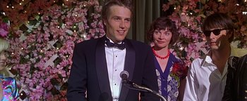 Movie still from “Never Been Kissed” (1999), directed by Raja Gosnell – A man standing next to a woman wearing a tuxedo; Close Up shot, Over the shoulder angle