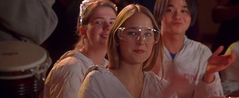 Movie still from “Never Been Kissed” (1999), directed by Raja Gosnell – A woman with glasses is looking at the camera; Close Up shot, Low angle