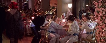 Movie still from “Never Been Kissed” (1999), directed by Raja Gosnell – A group of people sitting around a table; Medium shot, High angle