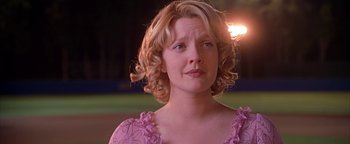 Movie still from “Never Been Kissed” (1999), directed by Raja Gosnell – A person with curly hair wearing a pink dress; Close Up shot, Over the shoulder angle