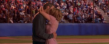 Movie still from “Never Been Kissed” (1999), directed by Raja Gosnell – A man and a woman kissing in front of an audience; Medium shot, Over the shoulder angle