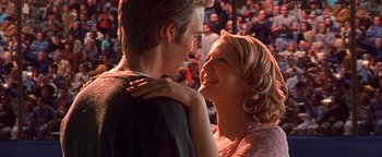 Movie still from “Never Been Kissed” (1999), directed by Raja Gosnell – A man and a woman smiling at each other; Close Up shot, Low angle
