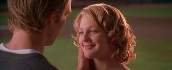 Movie still from “Never Been Kissed” (1999), directed by Raja Gosnell – A man and a woman smiling at each other; Close Up shot, Over the shoulder angle