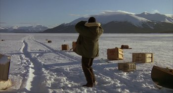 Movie still from “Never Cry Wolf” (1983), directed by Carroll Ballard – A man standing in the middle of a snow covered field; Extreme Wide shot, High angle