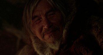 Movie still from “Never Cry Wolf” (1983), directed by Carroll Ballard – An old man with long hair and a beard; Close Up shot, Over the shoulder angle