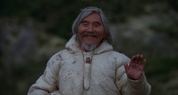 Movie still from “Never Cry Wolf” (1983), directed by Carroll Ballard – An old man with a beard and a white jacket; Medium shot, Low angle