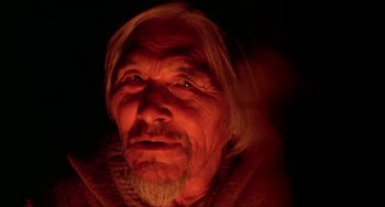 Movie still from “Never Cry Wolf” (1983), directed by Carroll Ballard – An old man with long white hair and wearing a sweater; Close Up shot, Low angle