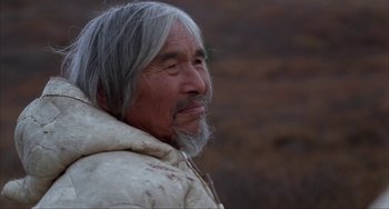 Movie still from “Never Cry Wolf” (1983), directed by Carroll Ballard – An older man with long gray hair and a beard; Close Up shot, Over the shoulder angle