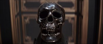 Movie still from “Never Say Never Again” (1983), directed by Irvin Kershner – A silver skull with a black background behind it; Extreme Close Up shot, Low angle