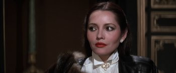 Movie still from “Never Say Never Again” (1983), directed by Irvin Kershner – A person wearing a necklace; Close Up shot, Low angle