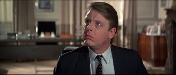 Movie still from “Never Say Never Again” (1983), directed by Irvin Kershner – A person wearing a suit and tie; Close Up shot, Over the shoulder angle