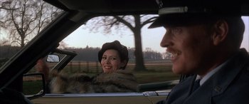Movie still from “Never Say Never Again” (1983), directed by Irvin Kershner – A man and a woman sitting in the back of a car; Close Up shot, Over the shoulder angle