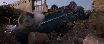 Movie still from “Never Say Never Again” (1983), directed by Irvin Kershner – A car that is sitting on the side of the road; Wide shot, High angle