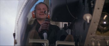 Movie still from “Never Say Never Again” (1983), directed by Irvin Kershner – A man in a helicopter holding a remote control; Medium shot, Low angle