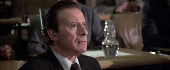 Movie still from “Never Say Never Again” (1983), directed by Irvin Kershner – A person wearing a suit and tie; Close Up shot, Low angle