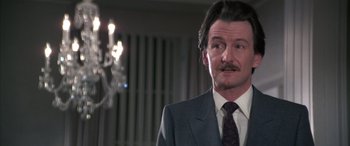 Movie still from “Never Say Never Again” (1983), directed by Irvin Kershner – A person wearing a suit and tie; Close Up shot, Low angle